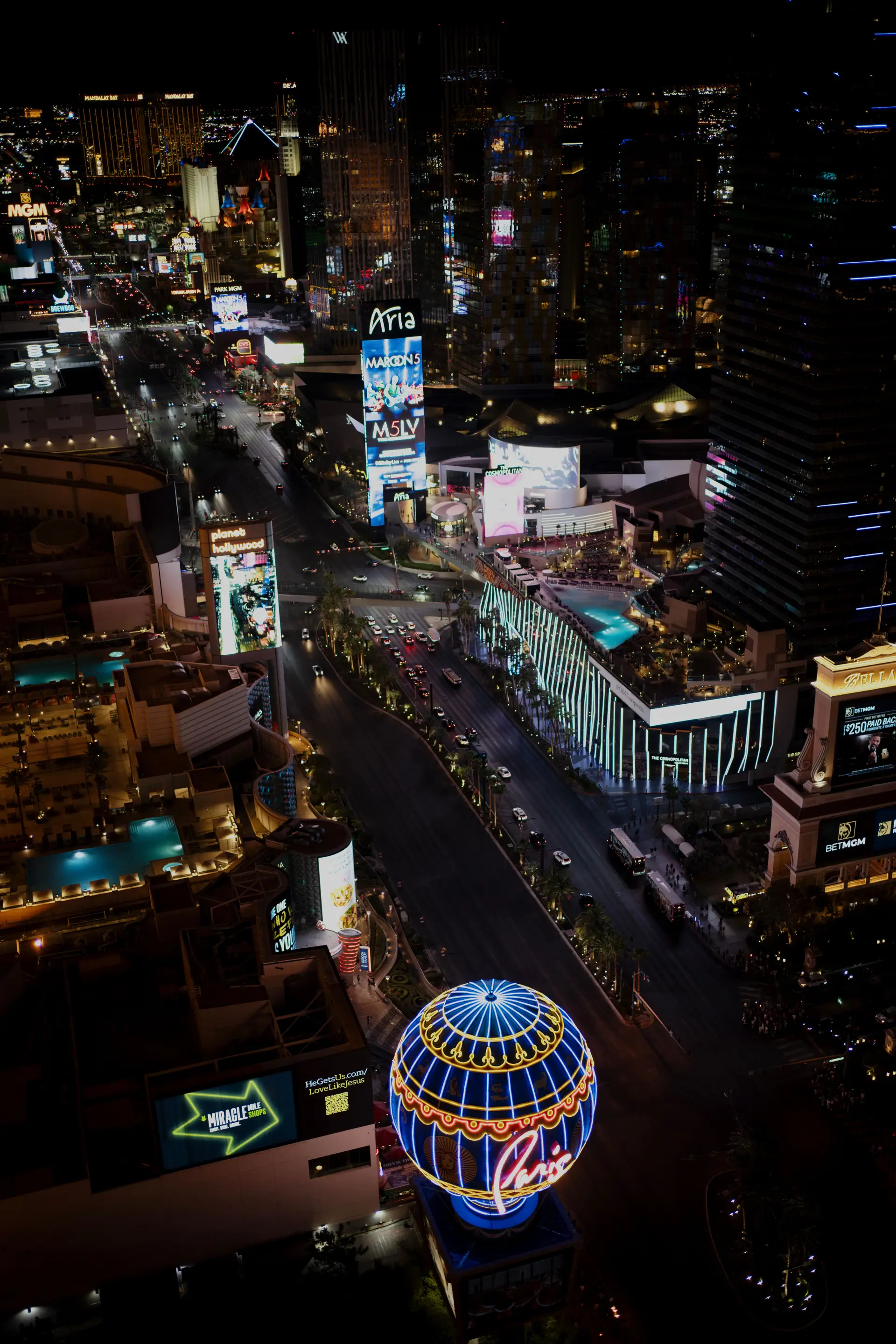 Aerial view of a vibrant casino resort at night with sparkling lights