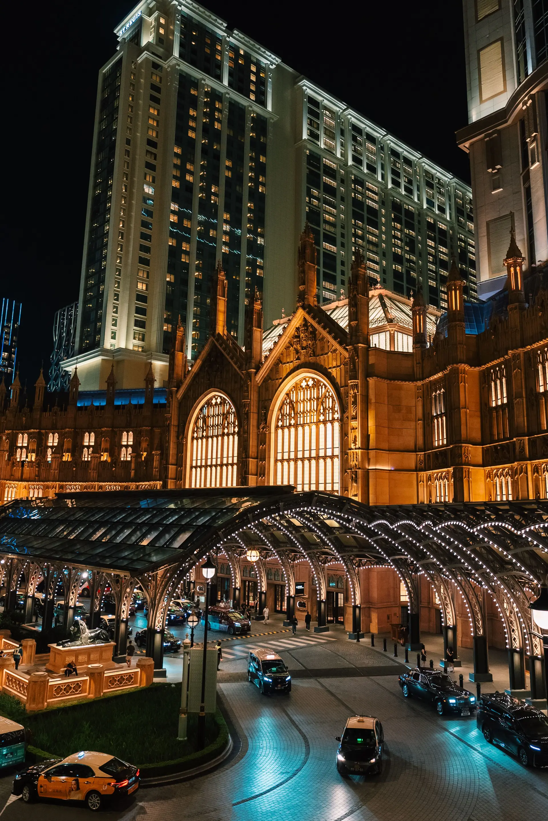 Grand illuminated entrance of Dravessiquegrandhaven Casino Hotel at night